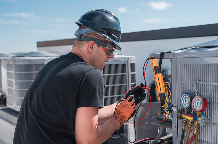 Technician working on hvac unit